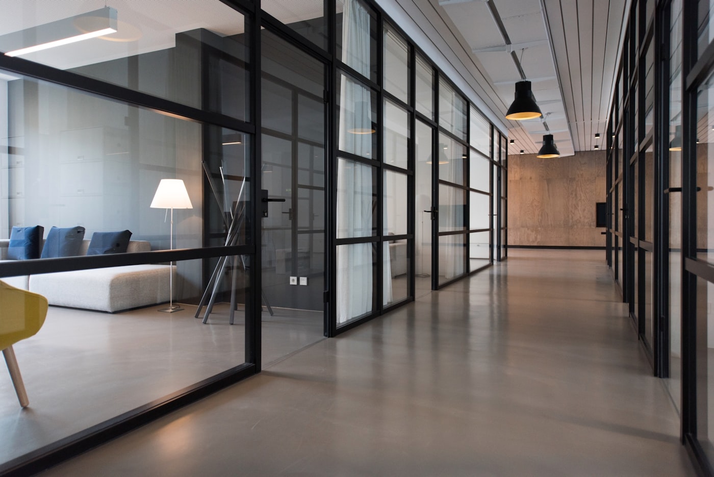 Sleek glass-walled modern office corridor